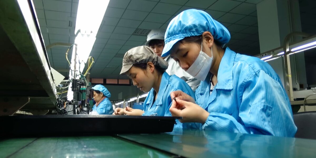 Workers assembling Wooting keyboard